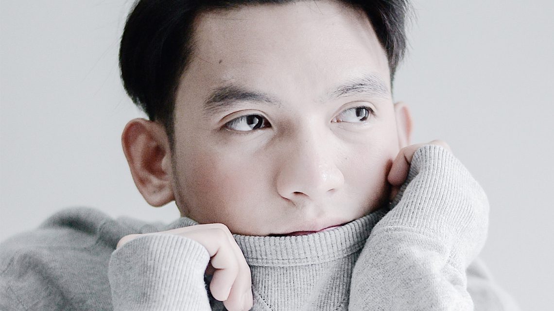 Man wearing gray long-sleeved top